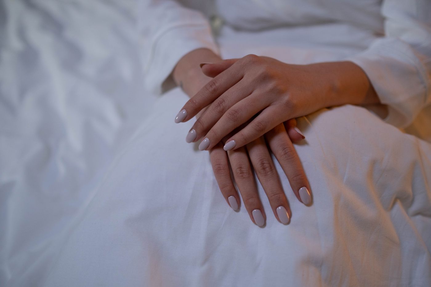 Elegant neutral manicure on softly posed hands